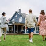 A young couple viewing a property for sale with an agent.