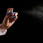 Luxury perfume being sprayed in the air.