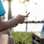 A person using a smartphone to scan a QR code when checking for a restaurant menu.