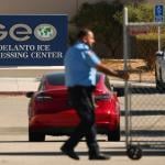 An officer closing a security gate at the GEO Group Adelanto ICE Processing Center in California.