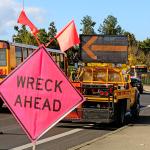 A 'wreck ahead' sign at a truck rollover accident.