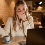 Young woman in shock by credit card information online.