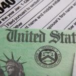 A U.S. tax refund check over a 1040 tax form.