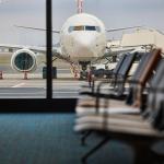 A view of a plane being refueled from the departure area of an airport.