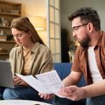Couple at home organizing tax documents.