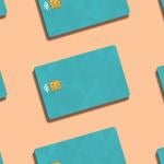 Teal credit cards against a peach background.
