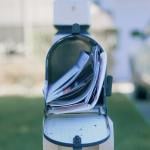 An opened mail box full of letters.
