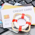 A small red lifebuoy on top of credit cards.