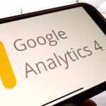 The Google Analytics 4 platform logo displayed on a smartphone.