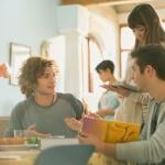 A group of college students having a conversation.