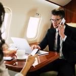  Businessman on a call while on a private flight.