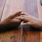 Two hands holding each other.