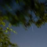 A satellite from a larger group of satellites called Starlink seen trailing across the night sky.