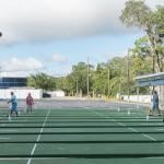 Older people playing shuffleboard at a resort.