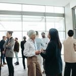 A diverse group of professionals networking at an event.