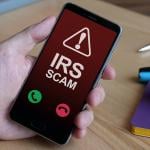 An Internal Revenue Service (IRS) scam call is displayed from a smartphone.