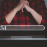 A floating search bar and a data analyst working on search engine concept from a laptop in the background.