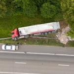 An aerial view of a truck accident scene on a highway.