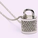 A bejeweled padlock with a string.