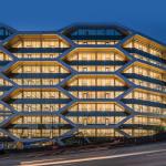 A night view of the 10-story mass timber office building known as The Hive located in Vancouver, British Columbia.