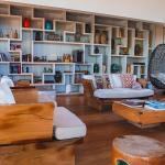 Interior of a luxury modern home's living room showcasing a wide shelf of antiques and books on display.