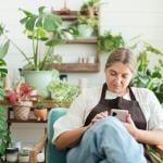 A female small garden business owner browsing information using a smartphone.