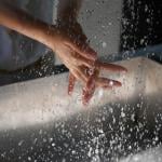 Person washing hands over a sink.