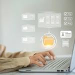 A person checking through virtual file folders from a laptop.