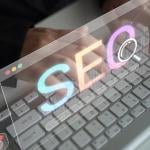 Holographic SEO concepts over a focused person using a keyboard.