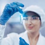 A female scientist checking water quality from a sample.