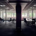 A female employee alone in a big office.