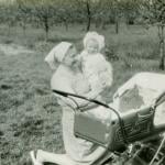 A vintage photo of a grandmother with her grandchild outdoors.