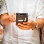 People using and sharing their smartphones' content with each other.