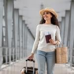 A traveller walking her way to the airport's departure gate. 