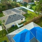 Aerial view of a house's roof damaged by Hurricane Ian in Florida.