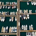 An aerial view of anchored yachts and boats at the docks in a marina.