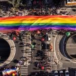An aerial shot of a massive pride flag from the 28th edition of São Paulo LGBT+ Pride Parade in Brazil.