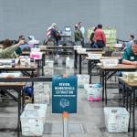 Election officials processing and counting official ballots during Election Day in Milwaukee, Wisconsin, USA.