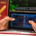 A young child paying Minecraft on a digital tablet.