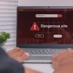 A dangerous site warning displayed on a laptop.