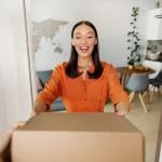 A happy woman receiving a package.