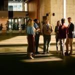 A group of entrepreneurs engaged in discussion at a conference venue.