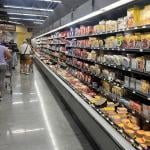 Customers shop in the deli meat aisle of a grocery store in Miami, Florida.