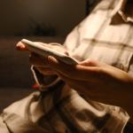A person checking her social media accounts from her smartphone.