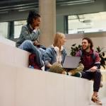 A diverse group of university students having a discussion in campus.