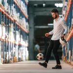 A storage working kicking a soccer ball.