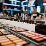 Close up shot of brushes and makeup palettes in a cosmetics store.