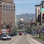 A view of the Idaho state capitol building downtown with overlooking mountains at the back.