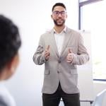 A business manager presenting a sales pitch sample during a workshop session.
