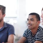 Office employees listening during a workshop session about team development in the workplace.